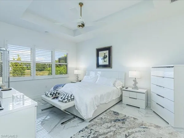 a bedroom with a large bed and a window