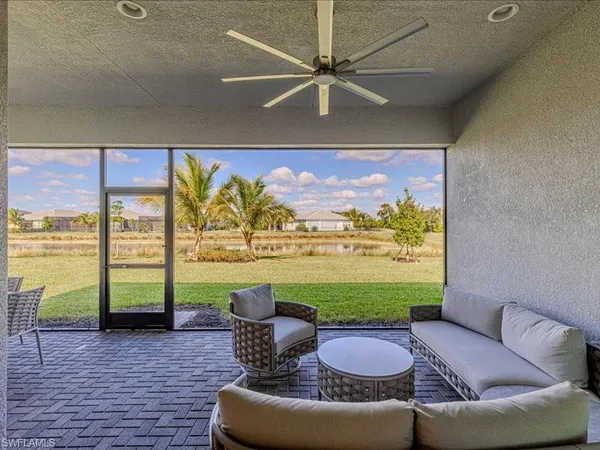 a living room with furniture and a floor to ceiling window
