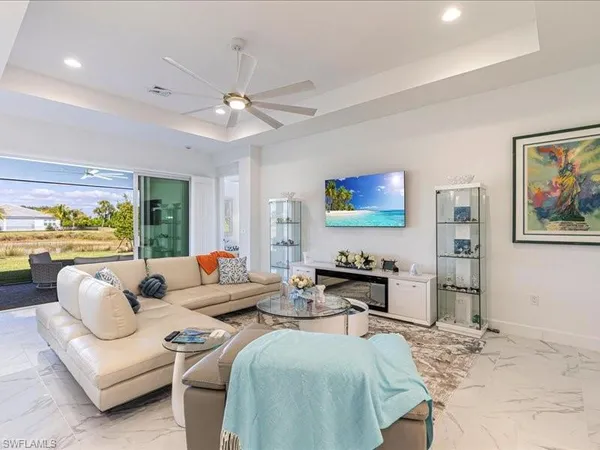 a living room with furniture a rug and a large window