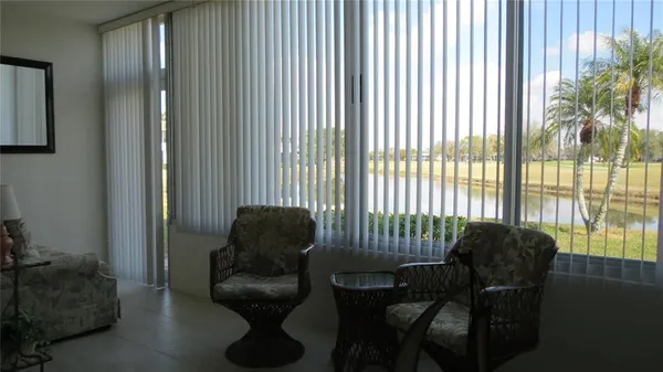 a living room with furniture and a floor to ceiling window