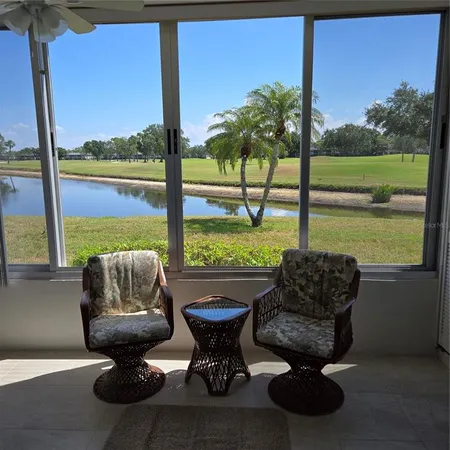 a living room with furniture and a floor to ceiling window