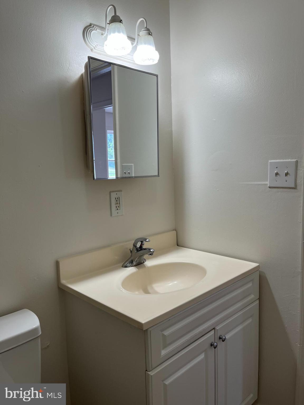 414 North High Street Martinsburg, WV 25404 - Photo 15 of 23 a bathroom with a sink toilet and mirror