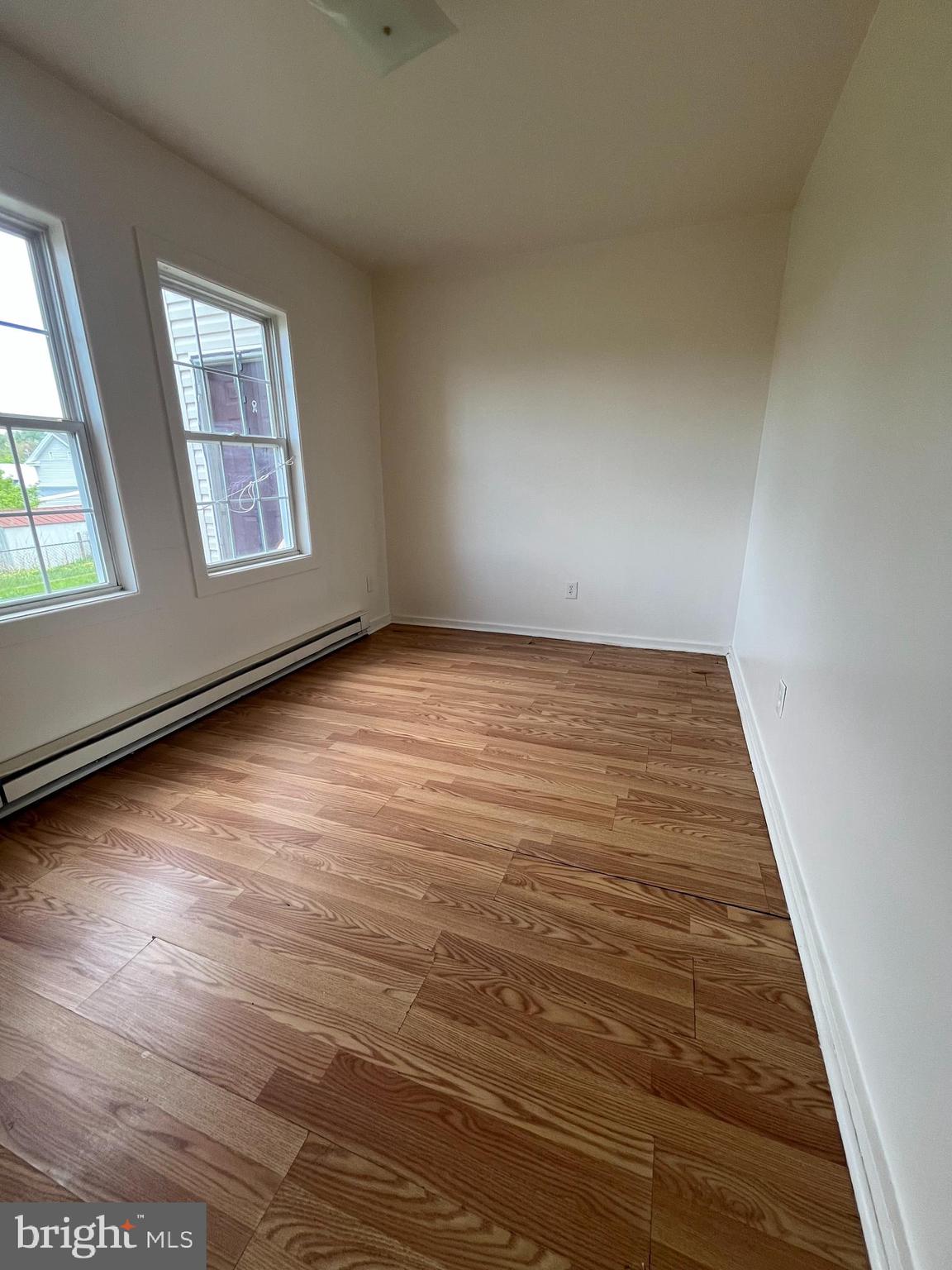 414 North High Street Martinsburg, WV 25404 - Photo 7 of 23 an empty room with wooden floor and windows