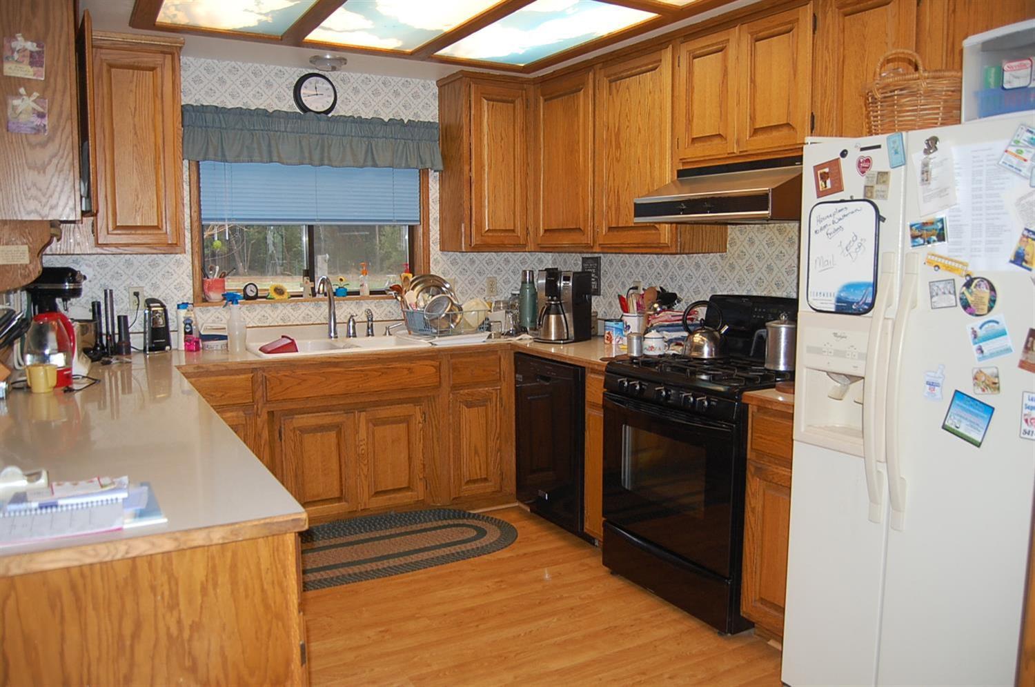 340 Fir Canyon Road Grants Pass, OR 97527 - Photo 6 of 26 U shaped kitchen with window looking to