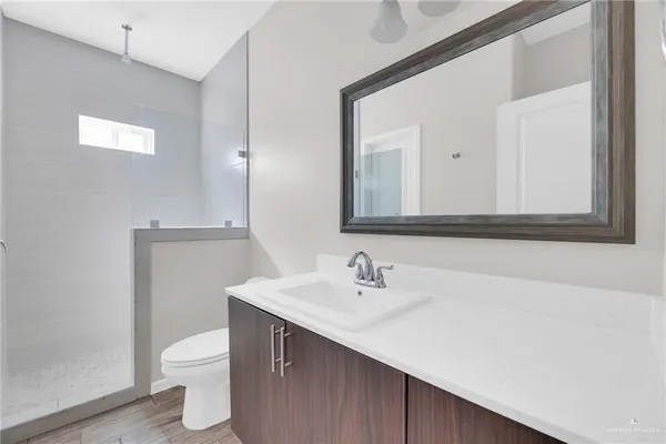 a bathroom with a sink a toilet and mirror