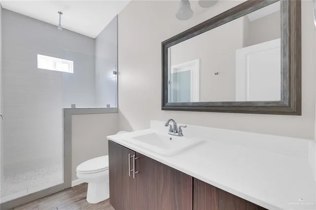 a bathroom with a sink a toilet and mirror