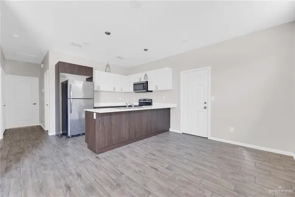 a view of kitchen with wooden floor