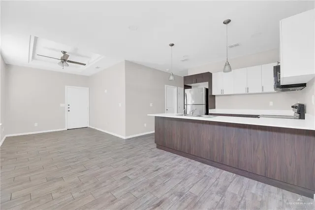 a kitchen with stainless steel appliances granite countertop a sink a stove and a wooden floors