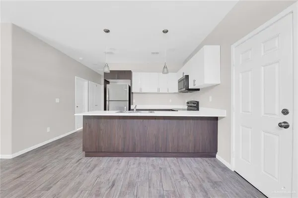 a view of kitchen with wooden floor