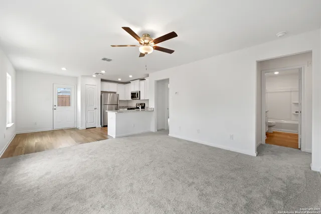 a view of a livingroom with a stove cabinets and a kitchen