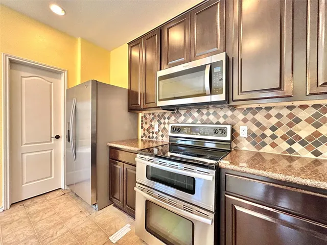 a bathroom with a granite countertop sink and a large mirror