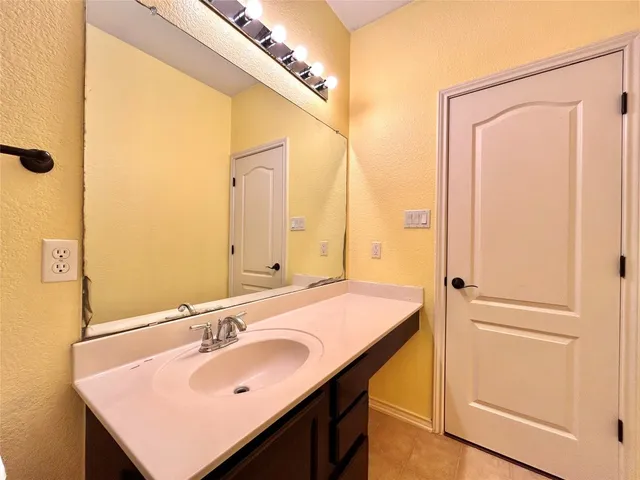 an empty room with a window and a ceiling fan