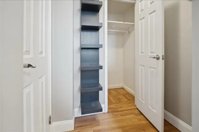 a view of hallway with wooden floor