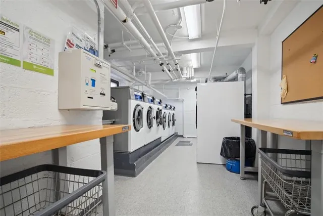 a lobby with furniture and potted plants