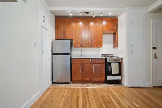 a view of kitchen with granite countertop cabinets and appliances