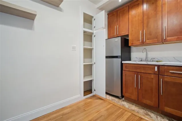 a kitchen with a refrigerator and cabinets