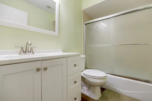 a bathroom with a sink toilet and a mirror