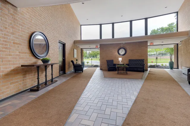 a living room with furniture a window and a chandelier
