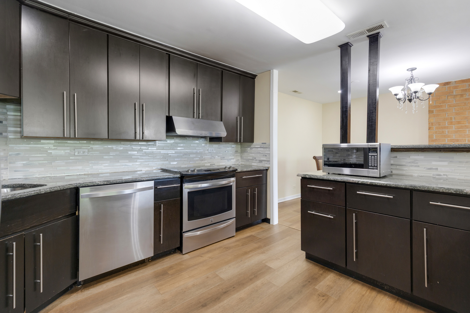 15 Bar Harbour Road, Unit 4F Schaumburg, IL 60193 - Photo 8 of 25 a kitchen with granite countertop stainless steel appliances and wooden cabinets
