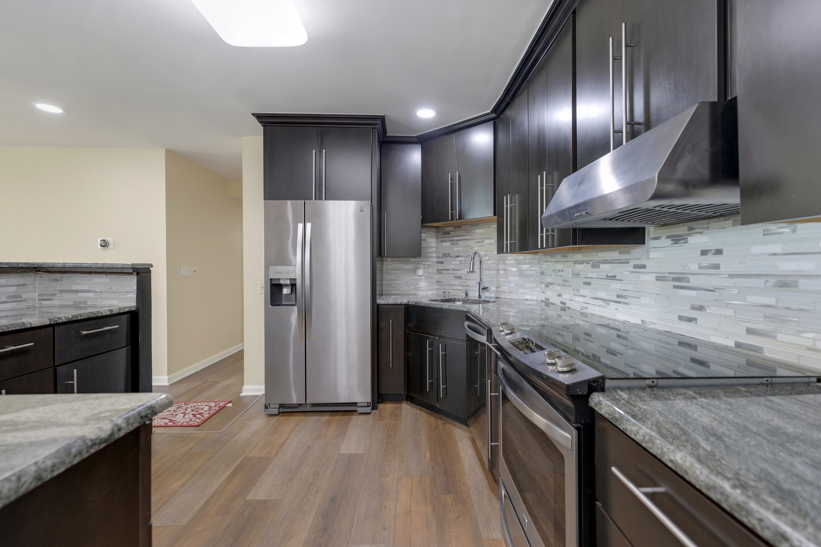 15 Bar Harbour Road, Unit 4F Schaumburg, IL 60193 - Photo 9 of 25 a kitchen with granite countertop stainless steel appliances and wooden cabinets