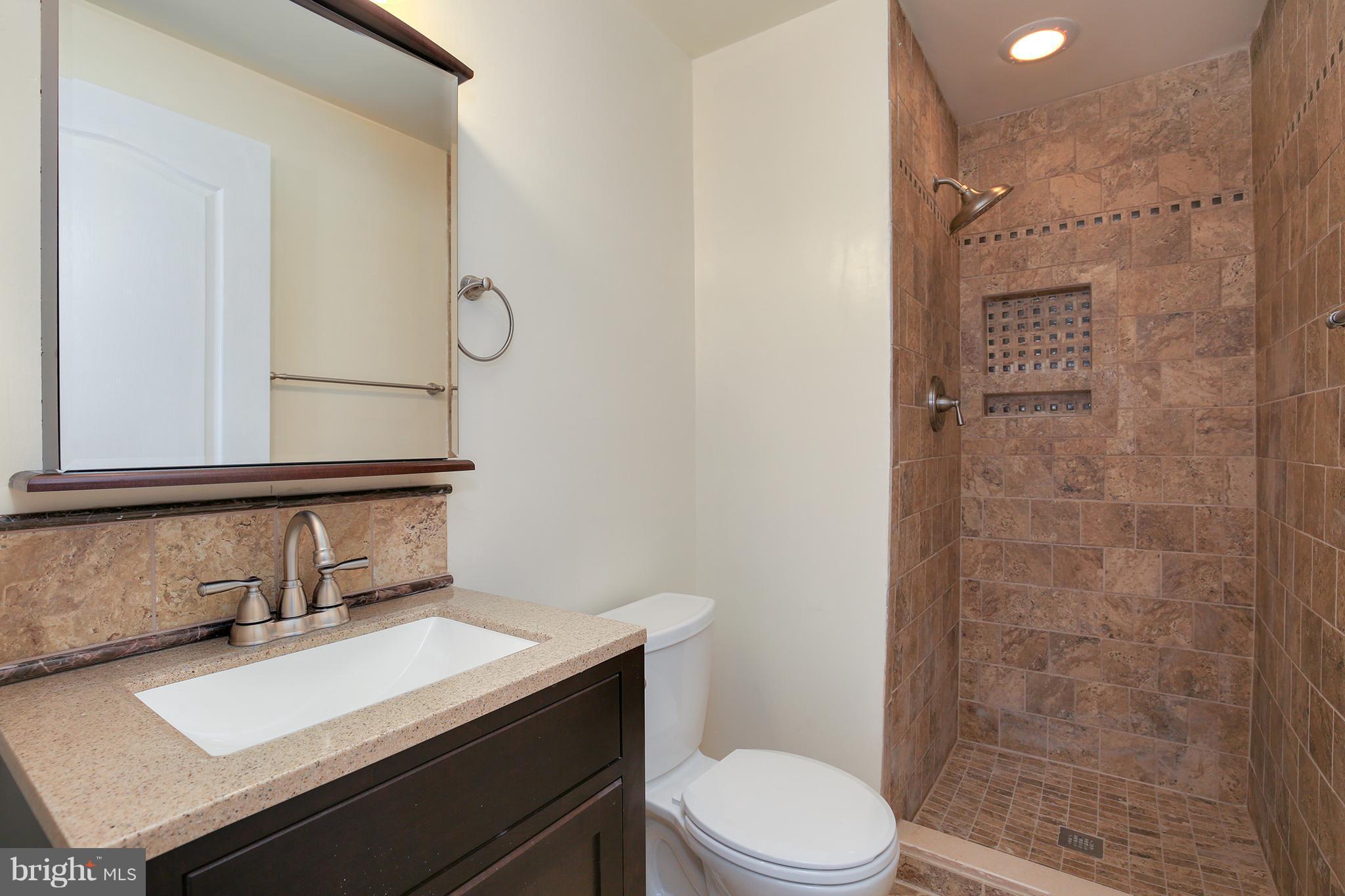 17555 Kohlhoss Road Poolesville, MD 20837 - Photo 16 of 24 a bathroom with a sink a toilet and shower