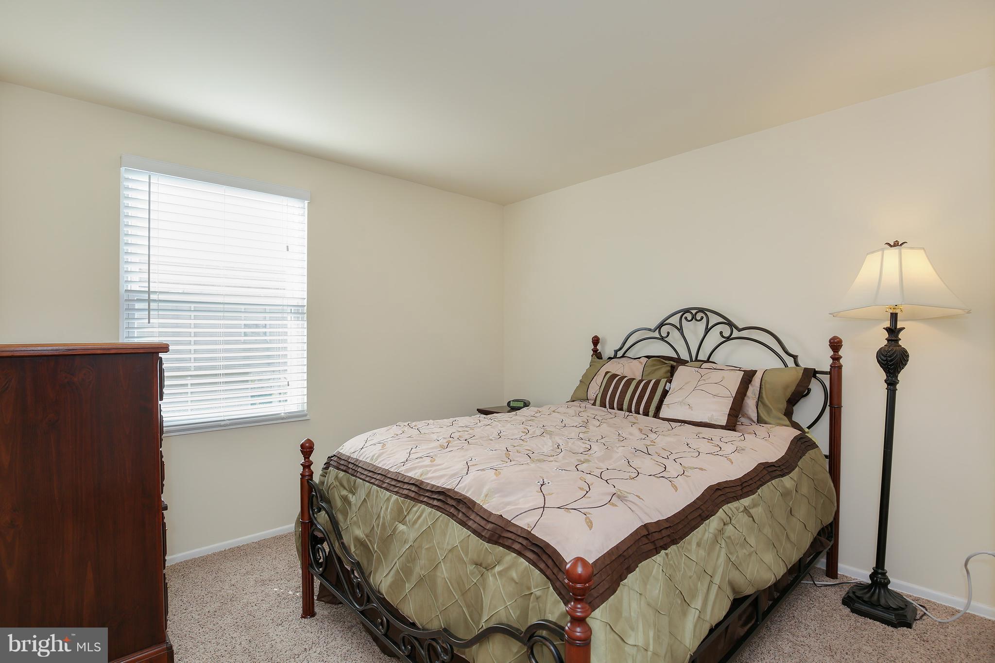 17555 Kohlhoss Road Poolesville, MD 20837 - Photo 17 of 24 a bedroom with a bed and a night stand