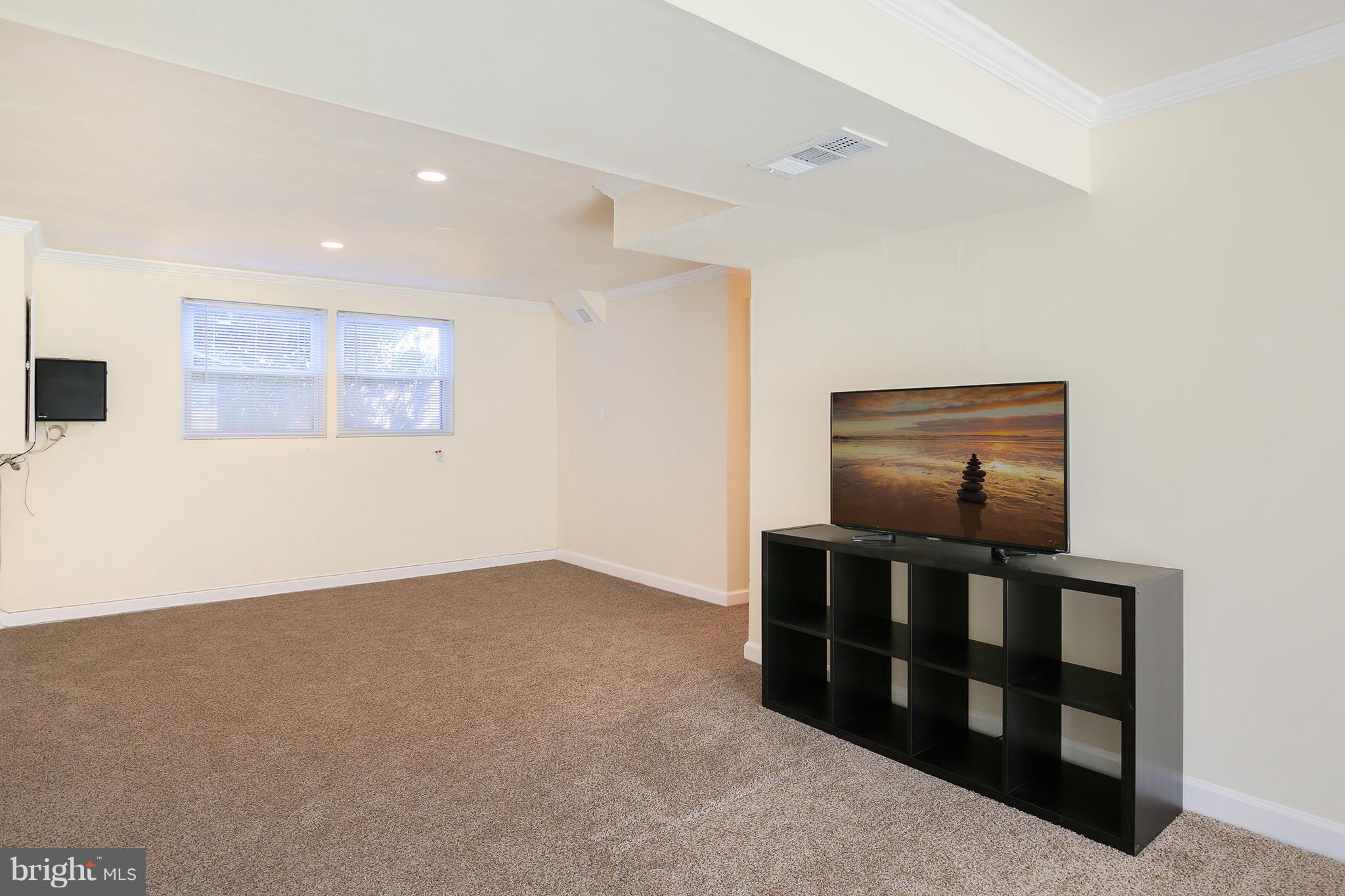 17555 Kohlhoss Road Poolesville, MD 20837 - Photo 20 of 24 a view of an empty room with wooden floor and cabinet
