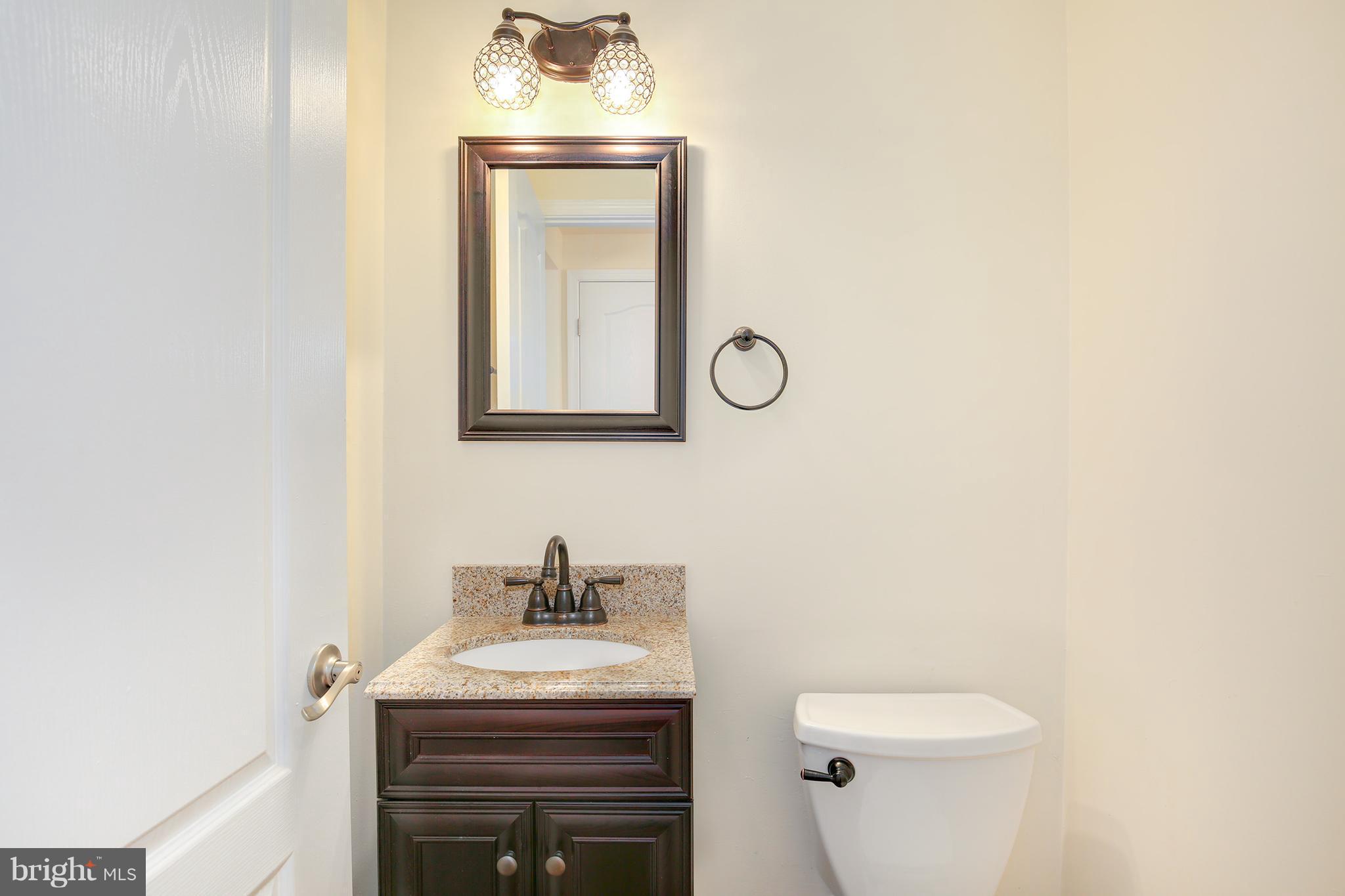 17555 Kohlhoss Road Poolesville, MD 20837 - Photo 21 of 24 a bathroom with a toilet sink vanity and mirror
