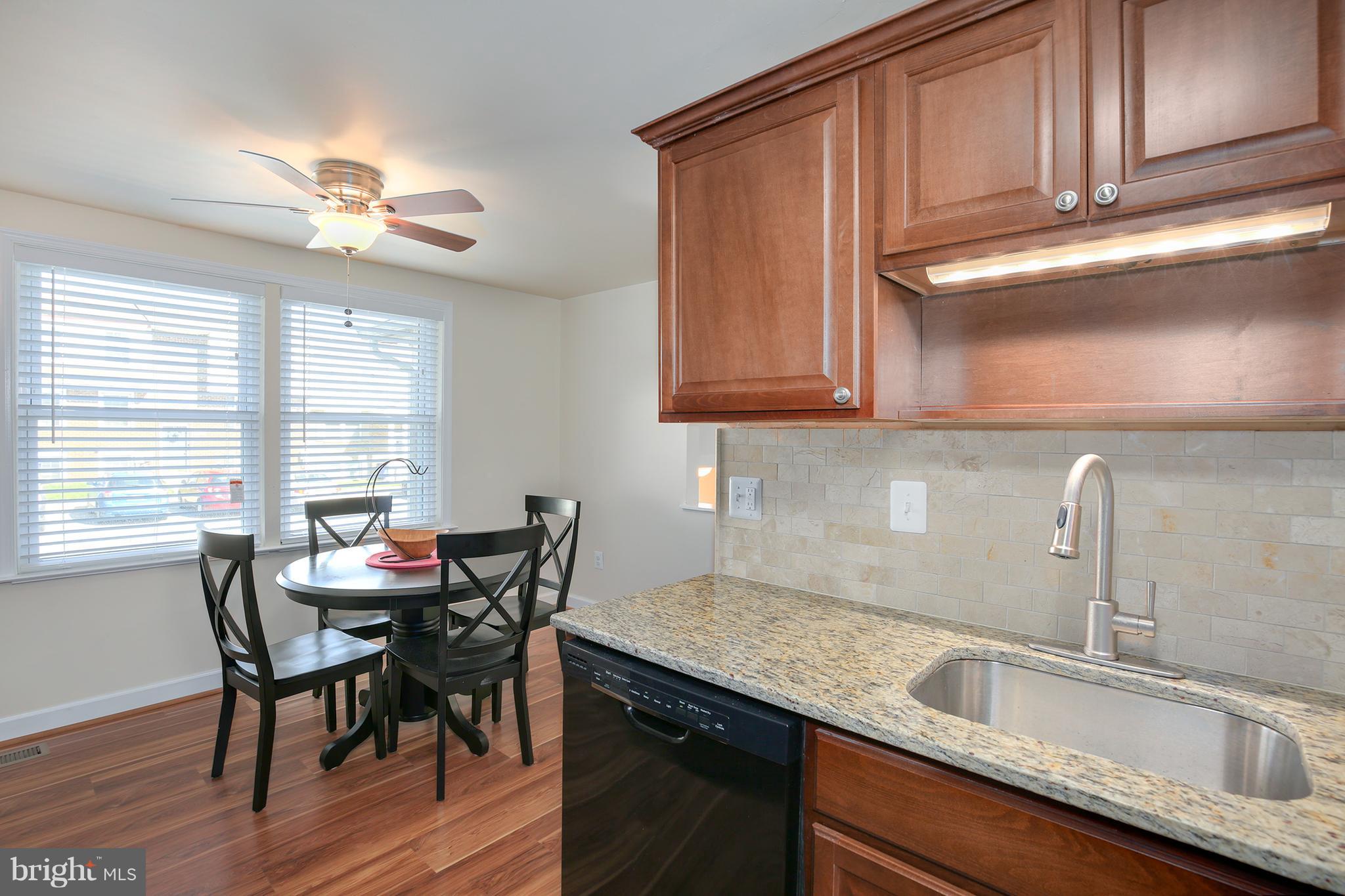 17555 Kohlhoss Road Poolesville, MD 20837 - Photo 22 of 24 a kitchen with granite countertop a sink cabinets and window