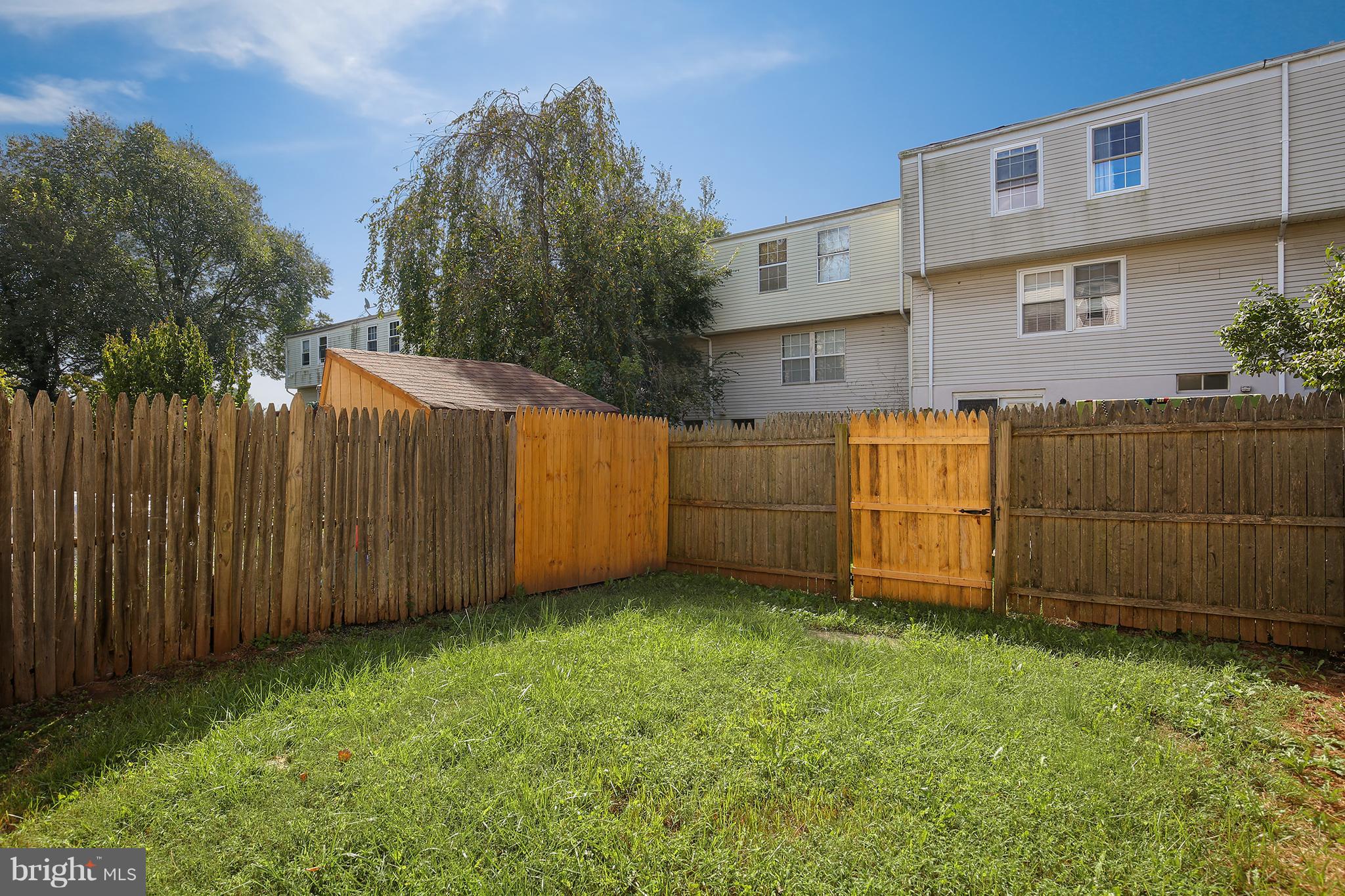 17555 Kohlhoss Road Poolesville, MD 20837 - Photo 23 of 24 a view of backyard with potted plants and wooden fence