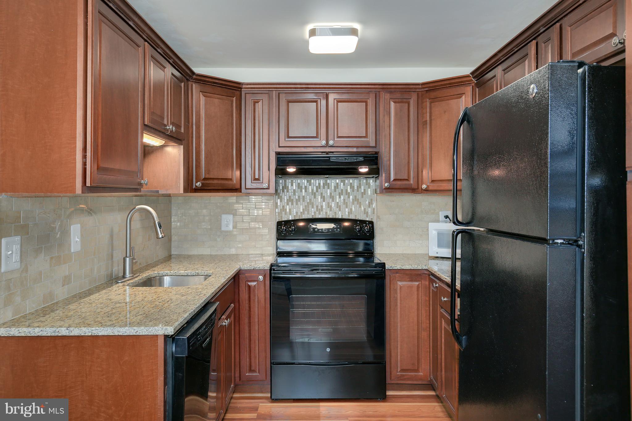 17555 Kohlhoss Road Poolesville, MD 20837 - Photo 8 of 24 a kitchen with a refrigerator sink and cabinets