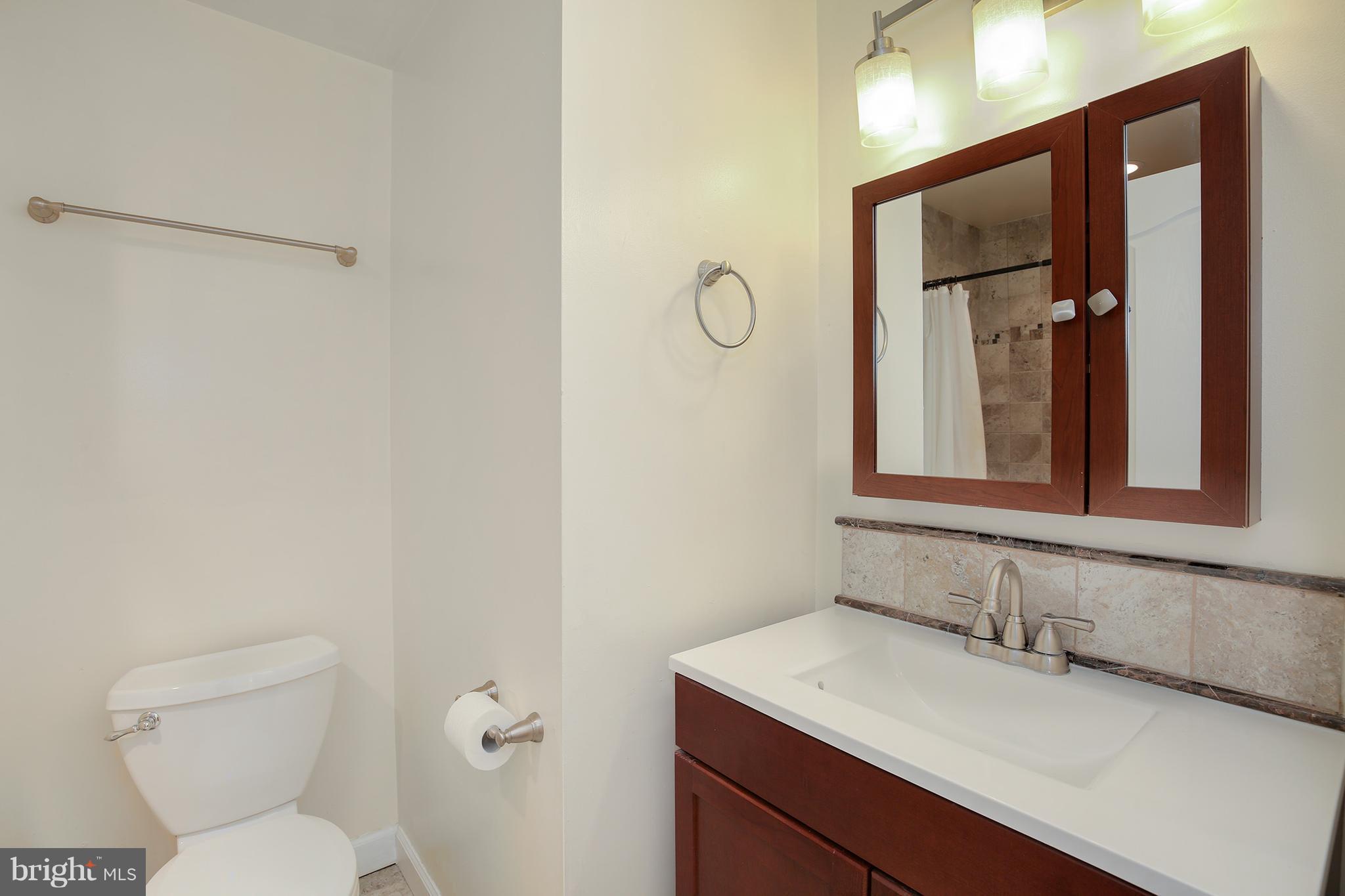 17555 Kohlhoss Road Poolesville, MD 20837 - Photo 10 of 24 a bathroom with a granite countertop sink mirror vanity and toilet