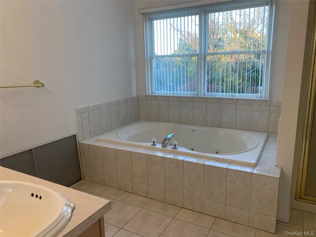 a bath tub sitting in a bathroom next to a window