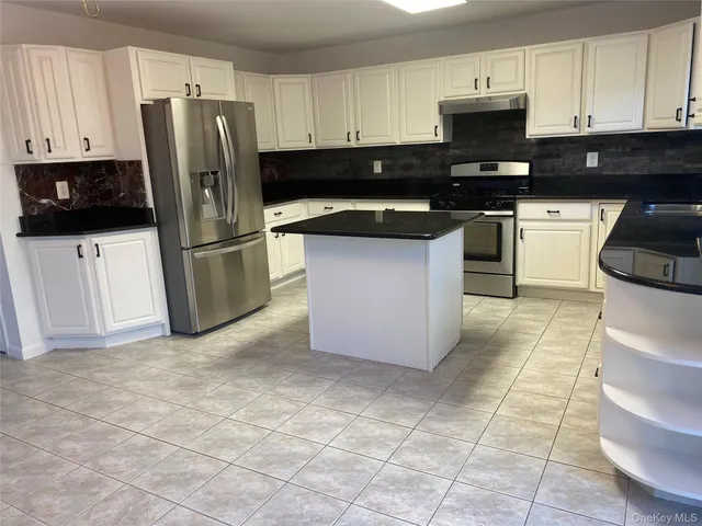 a kitchen with stainless steel appliances a refrigerator sink and microwave
