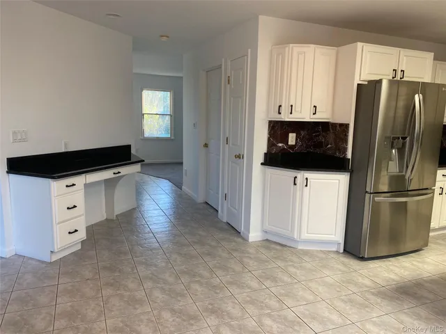 a kitchen with kitchen island a sink stainless steel appliances and cabinets