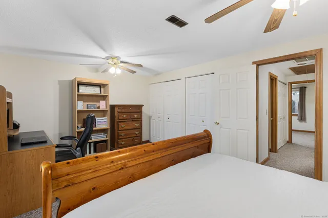 a bedroom with a bed and a chandelier