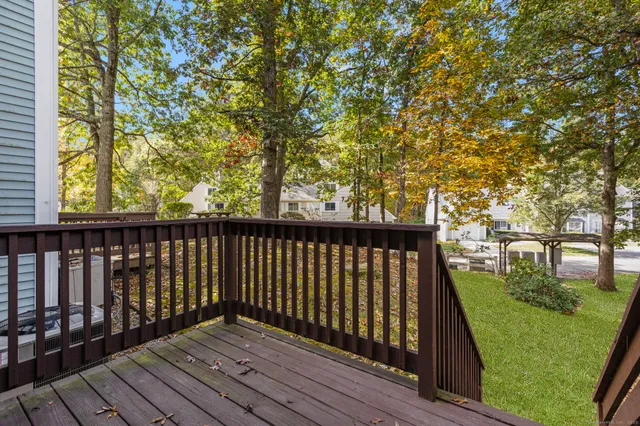 a balcony with wooden floor and trees