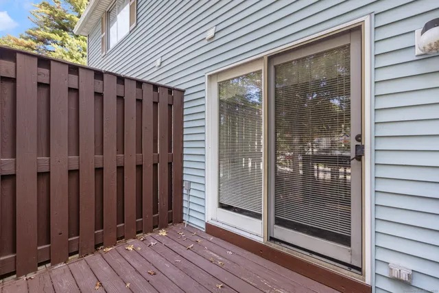a view of a balcony with floor to ceiling window wooden floor and wooden fence