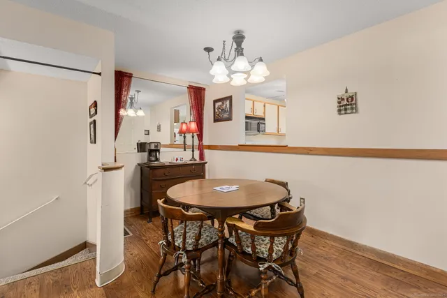 a dining room with furniture and chandelier