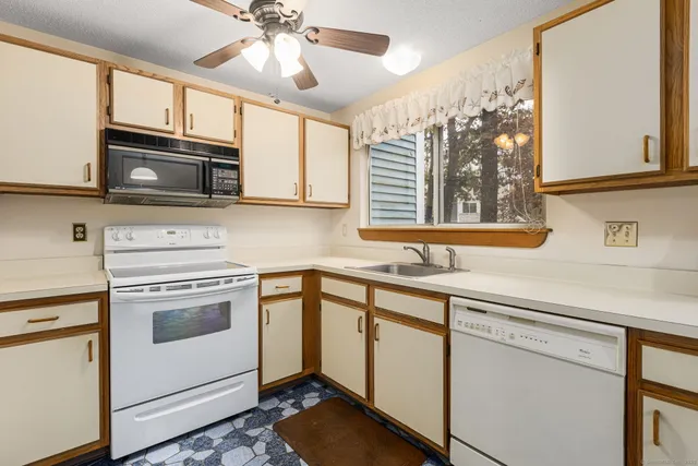 a kitchen with granite countertop cabinets stainless steel appliances and a sink