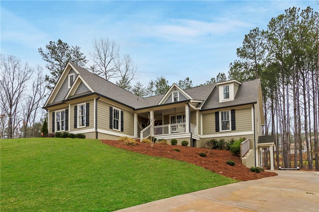 Home sweet home!  Separate driveways to the 2-car courtyard left side garage and the side entry 3rd car garage on the right side of the home.  Southern beauty with a welcoming front porch, back screened porch and a grilling deck. 