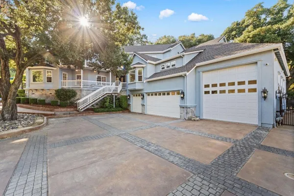 a view of a white house with a street
