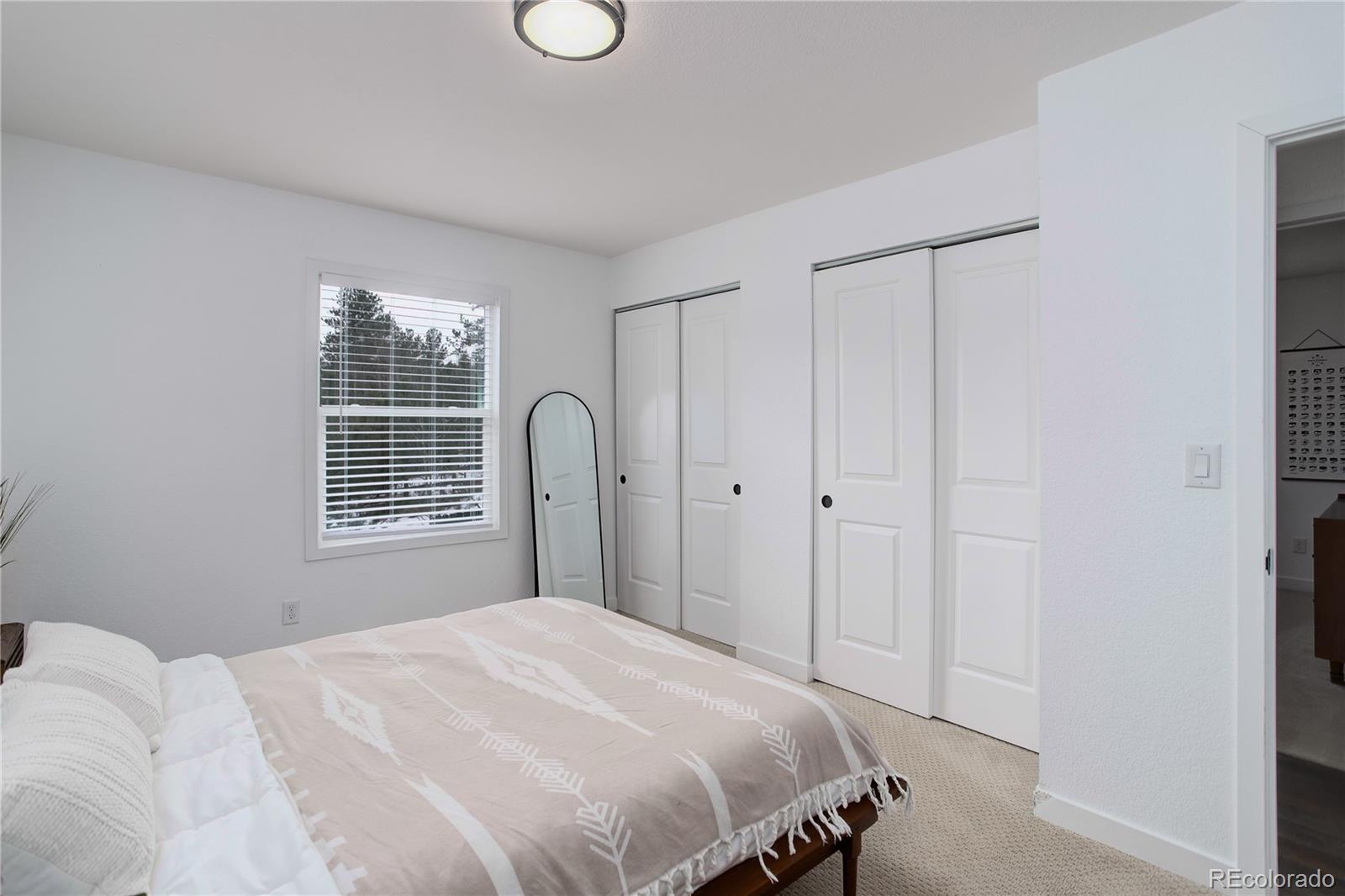 95 Fitzsimmons Road Bailey, CO 80421 - Photo 14 of 38 a bedroom with a bed and a window