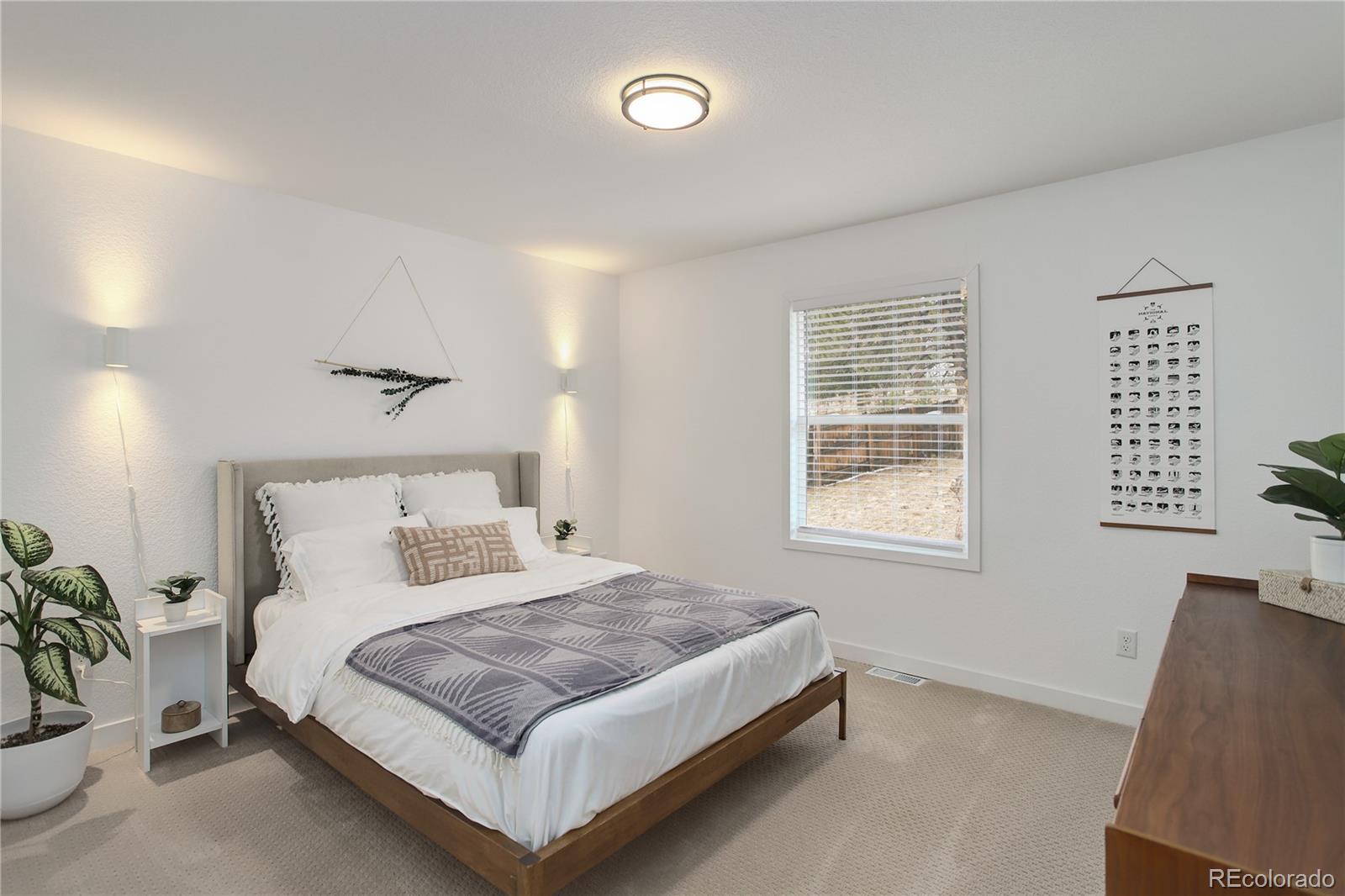 95 Fitzsimmons Road Bailey, CO 80421 - Photo 16 of 38 a bedroom with a bed and a window