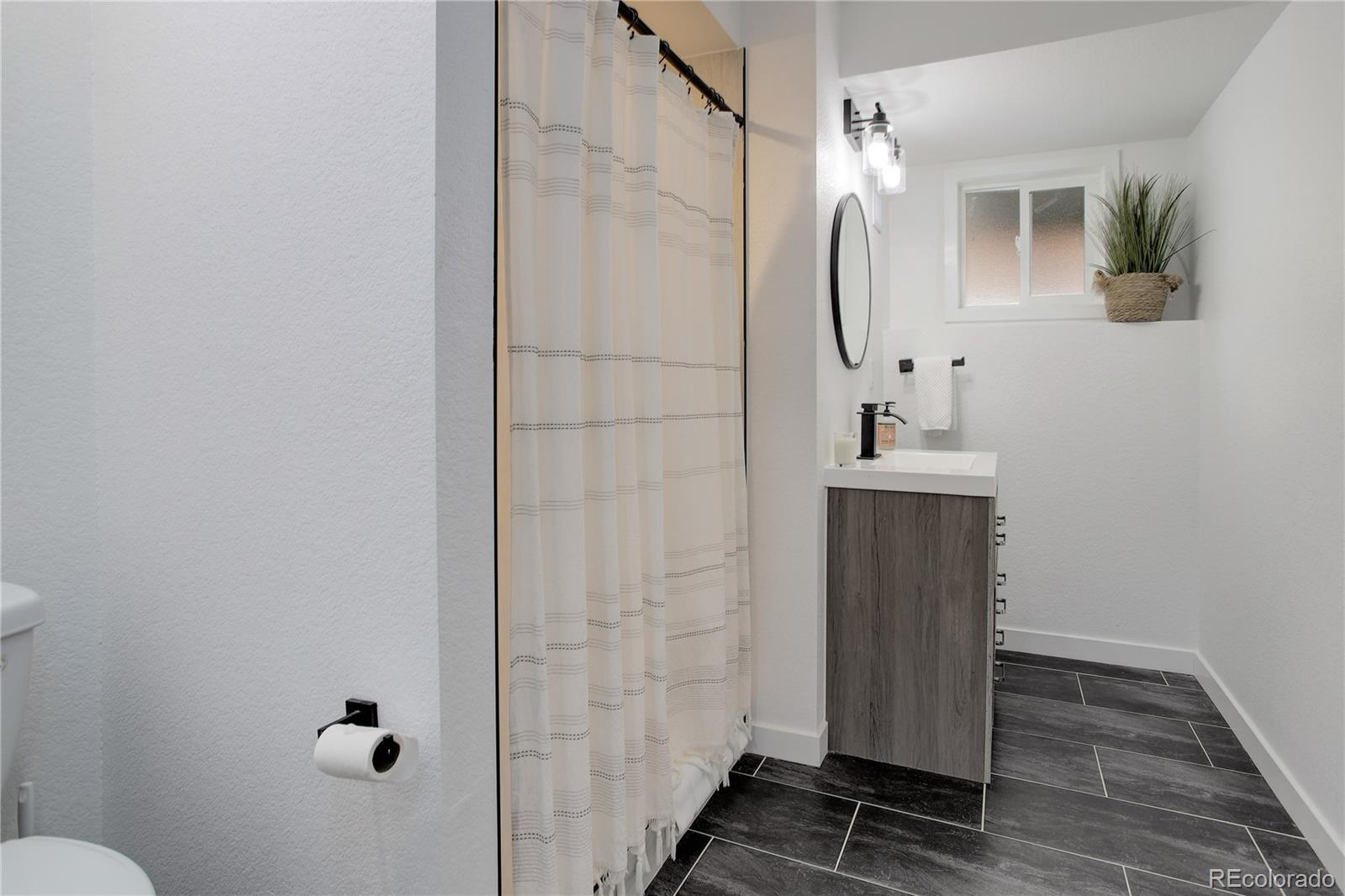 95 Fitzsimmons Road Bailey, CO 80421 - Photo 26 of 38 a bathroom with a mirror and a shower