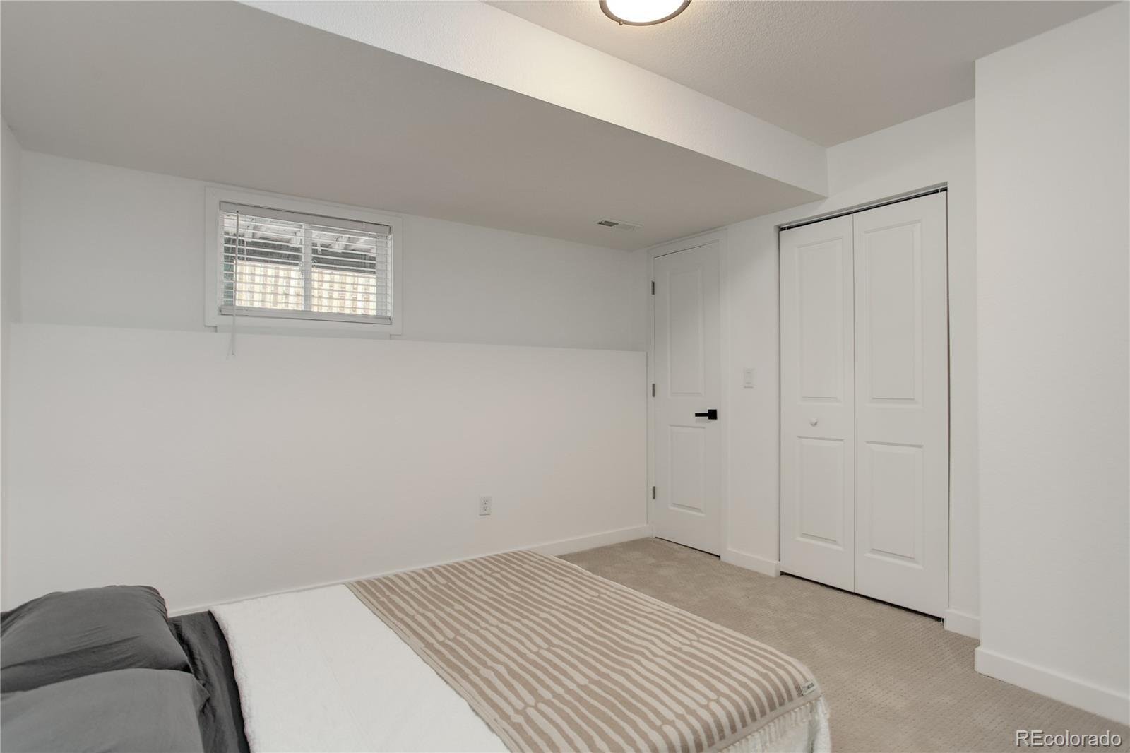 95 Fitzsimmons Road Bailey, CO 80421 - Photo 27 of 38 a view of a bedroom with wooden floor