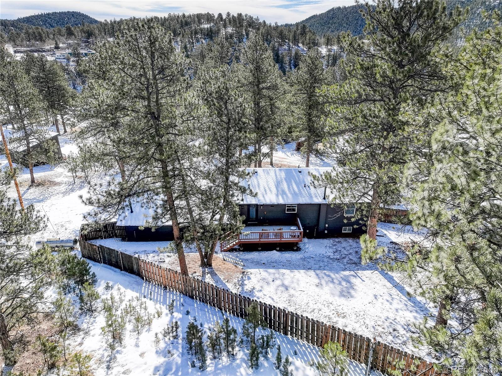 95 Fitzsimmons Road Bailey, CO 80421 - Photo 30 of 38 a view of a bench in the backyard