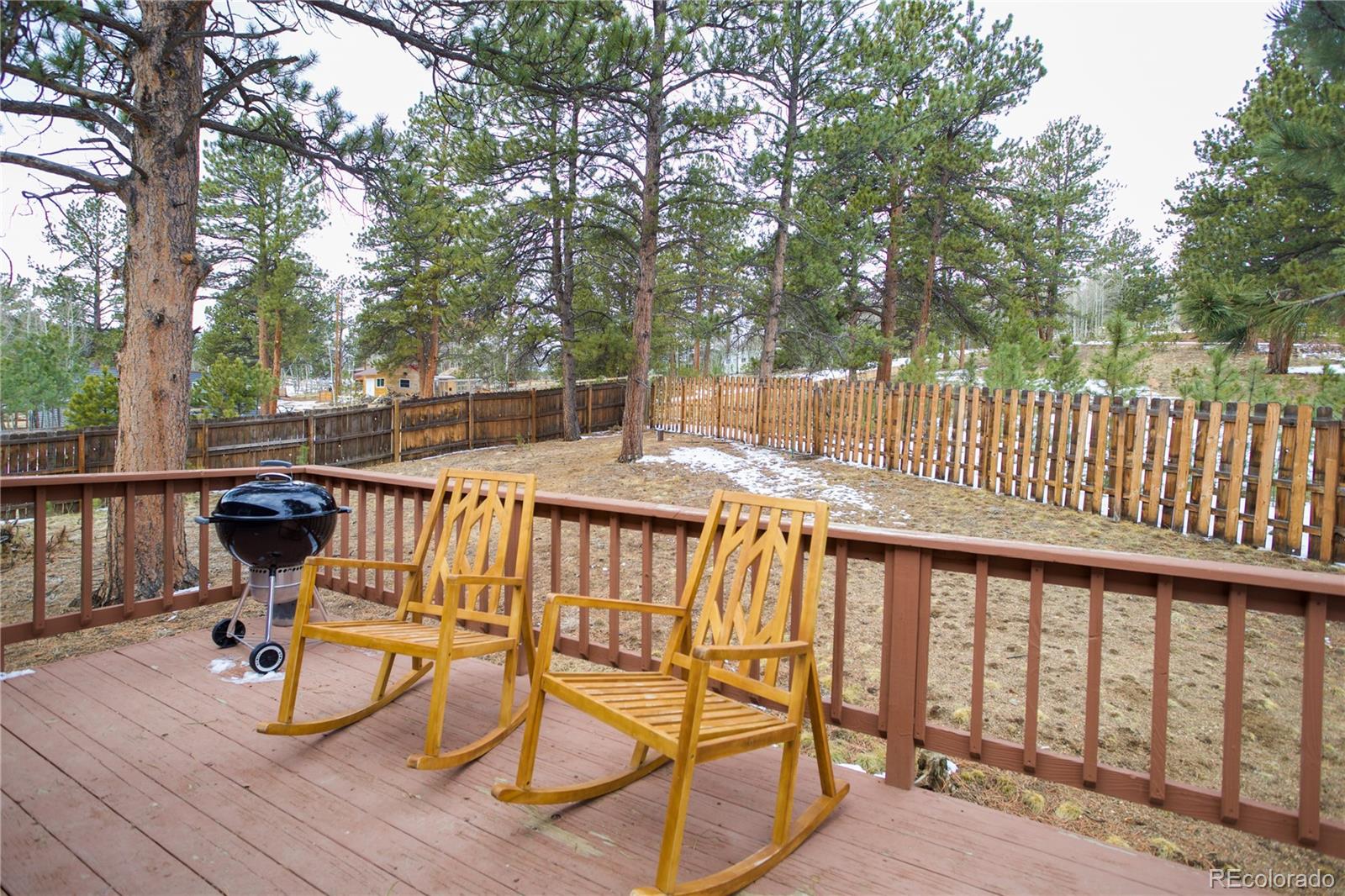 95 Fitzsimmons Road Bailey, CO 80421 - Photo 31 of 38 a view of balcony with wooden floor and outdoor seating