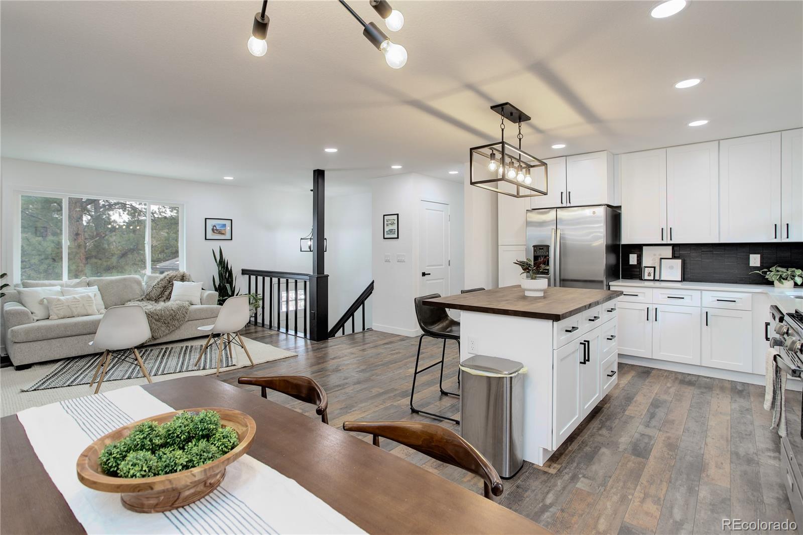 95 Fitzsimmons Road Bailey, CO 80421 - Photo 4 of 38 a large kitchen with lots of counter space a sink a window and stainless steel appliances