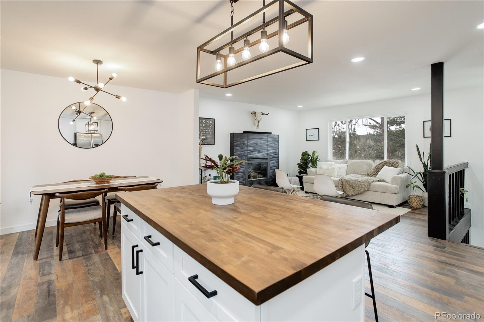 95 Fitzsimmons Road Bailey, CO 80421 - Photo 7 of 38 a kitchen with a table chairs and wooden floor